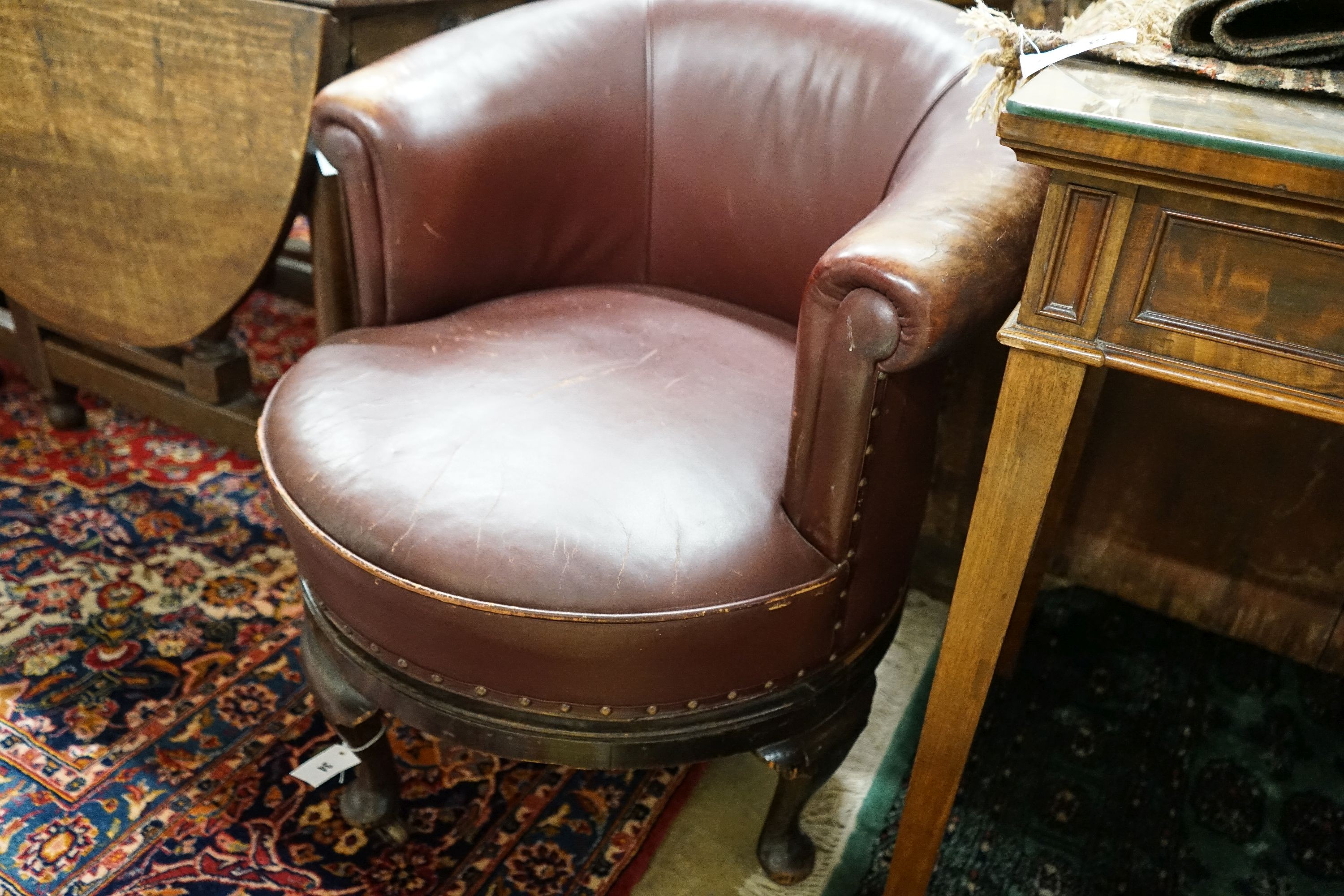 A late Victorian mahogany burgundy leather tub frame swivel desk chair, width 72cm, depth 62cm, height 74cm